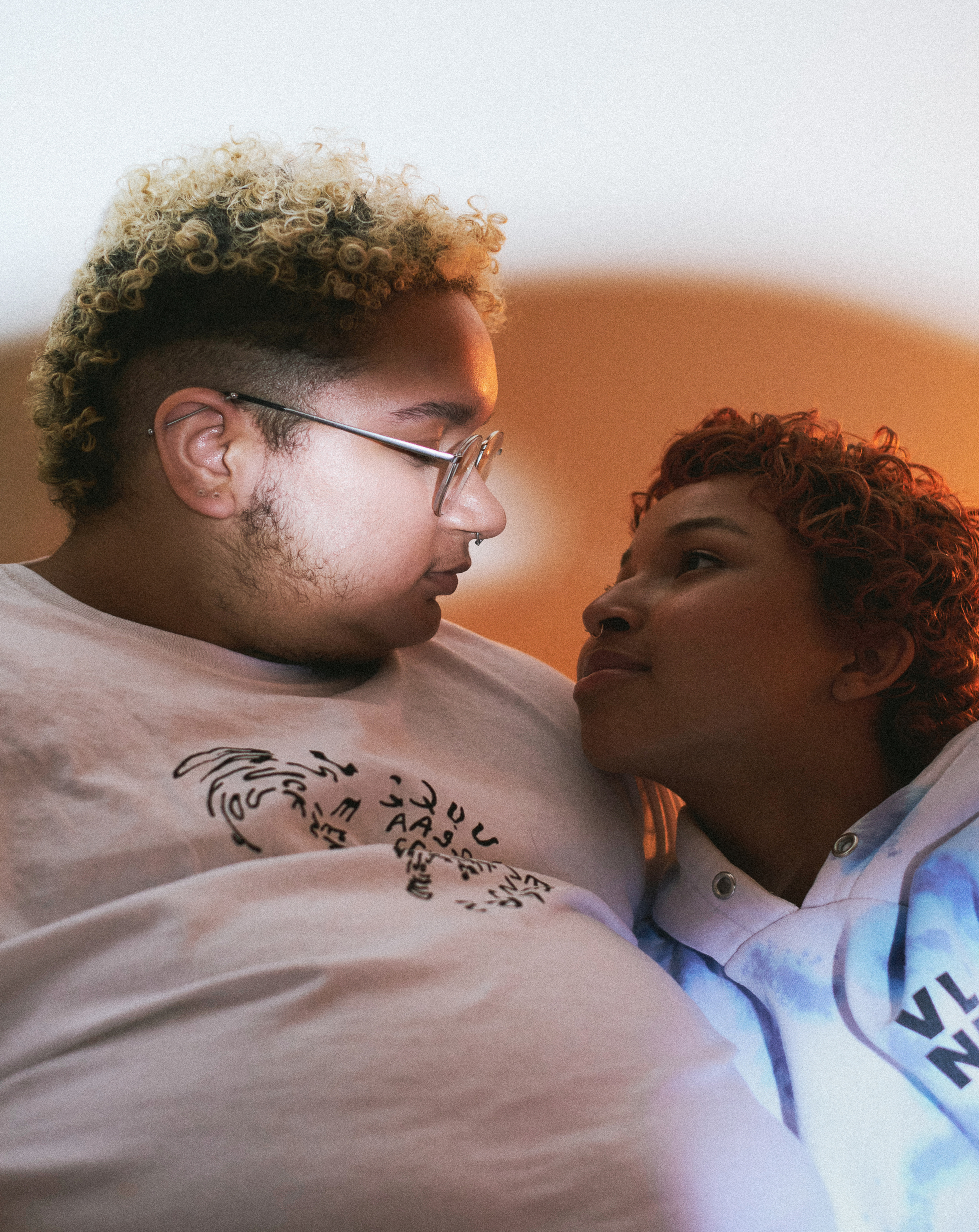 A trans couple looking into each other's eyes